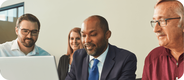 Business team reviewing laptop
